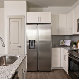 kitchen with ample counter-space, modern appliances and bright lighting