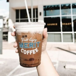 a held coffee outdoors